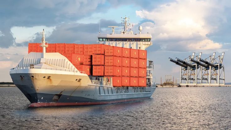 Cargo ship sailing across open sea transporting goods from China to the UK.