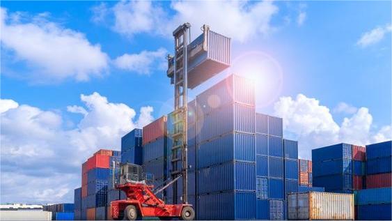 Open top container being loaded with solar panel crates at a Chinese port